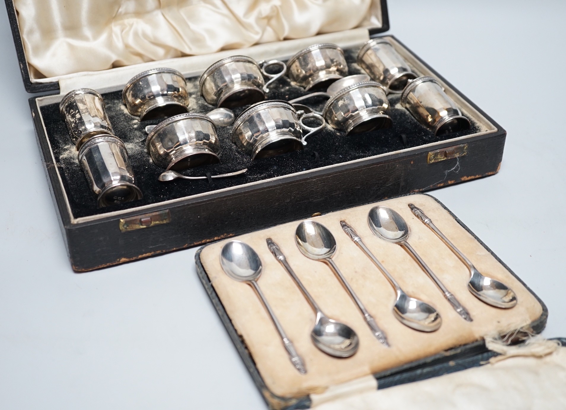 A cased George V ten piece silver condiment set, with four (ex 6) spoons, maker, RR, Birmingham, 1936 and London, 1929, together with a cased set of six silver teaspoons.